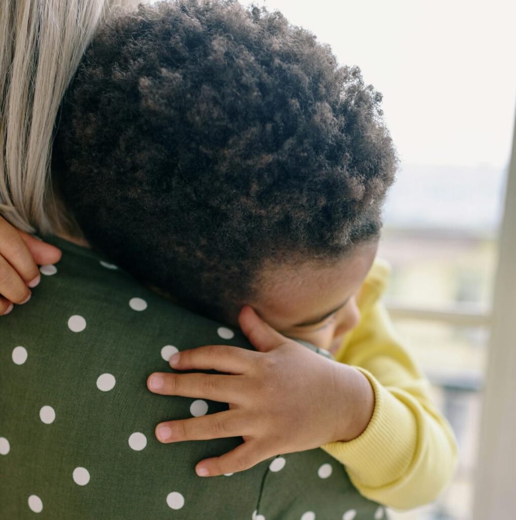 A parent holding their autistic child close