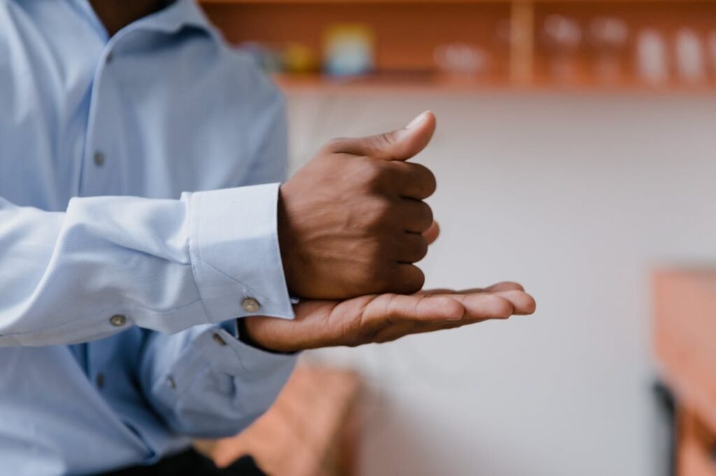 A parent using sign language to communicate with their nonverbal autistic child.