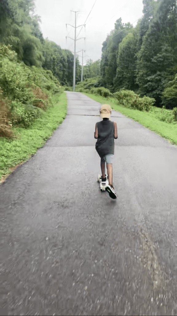 A nonverbal autistic child showing riding scooter ability.