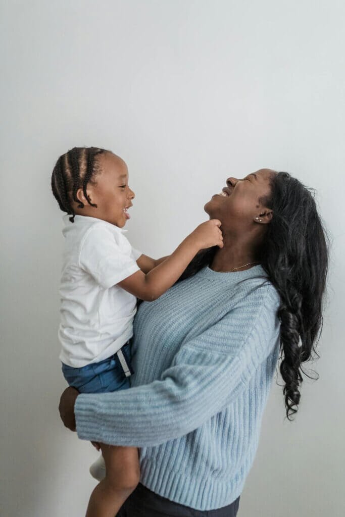 A nonverbal autistic child laughing and playing, showing joy in nonverbal social interactions."