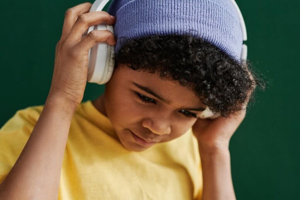 A nonverbal autistic child enjoying instrumental music, showcasing nonverbal connection through shared experiences.