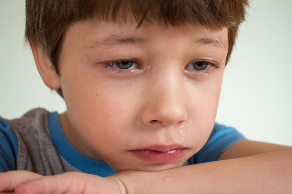 A nonverbal child with autism crying because of pain