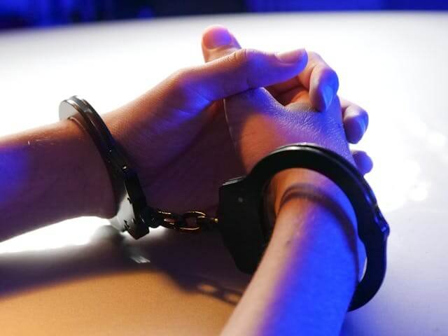 Handcuffed person representing nonverbal autism and law-enforcement misunderstanding