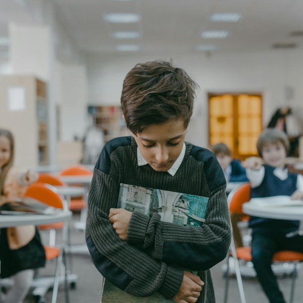 Nonverbal child in a classroom, highlighting systemic barriers in education and healthcare.